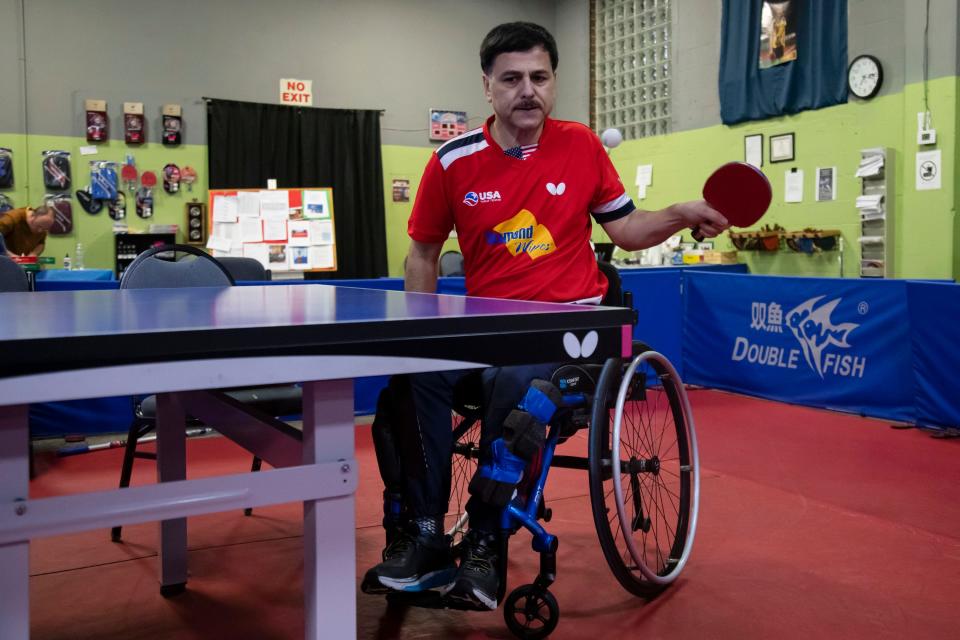 Ahad Sarand plays table tennis at the Columbus Table Tennis Club last week. Sarand, an Iranian immigrant, plays table tennis for Team USA in the Paralympics and represents the United States in international competitions.