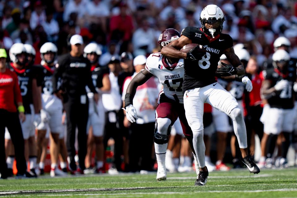 Cincinnati Bearcats wide receiver Xzavier Henderson (8) catches a pass as Eastern Kentucky Colonels linebacker Cheikhsaliou Fall (17) chases him down in the second quarter of the NCAA football game between the Cincinnati Bearcats and the Eastern Kentucky Colonels at Nippert Stadium in Cincinnati on Saturday, Sept. 2, 2023.