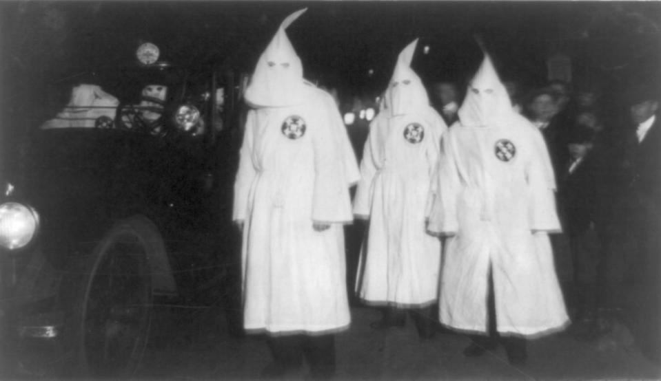 <p>Three Ku Klux Klan members standing beside automobile driven by Klan members in March, 1922. (Photo: Universal History Archive/Getty Images) </p>