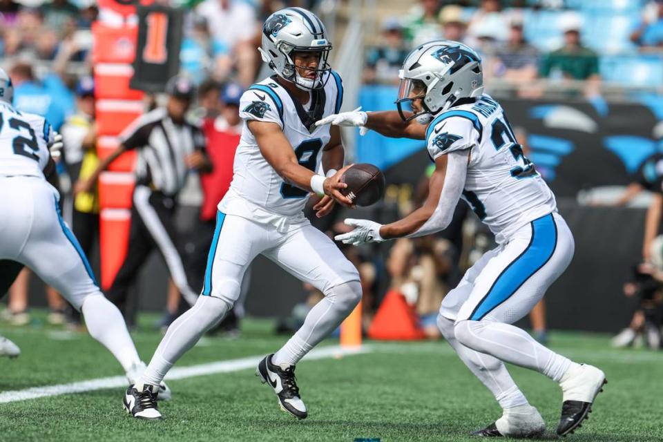 Panthers quarterback Bryce Young, left, hands the ball off to running back Chuba Hubbard during the pre-season game against the Jets at Bank of America Stadium on Saturday, August 12, 2023 in Charlotte, NC.