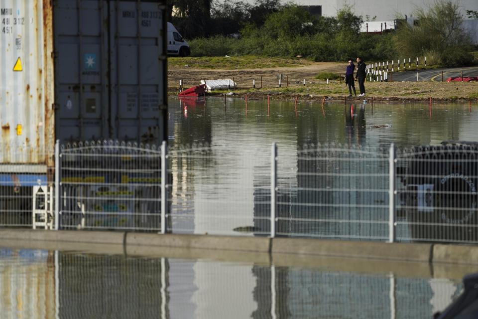 People look out at floodwater covering a major road in Dubai, United Arab Emirates, Wednesday, April 17, 2024 (Copyright 2024 The Associated Press. All rights reserved)
