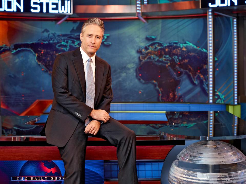 This undated image released by Comedy Central shows Jon Stewart on the set of "The Daily Show with Jon Stewart" in New York. The Comedy Central show is decamping for both the Republican and Democrat conventions to broadcast a week of shows at each that will parody the nation's most extravagant political pageants. (AP Photo/Comedy Central, Martin Crook)