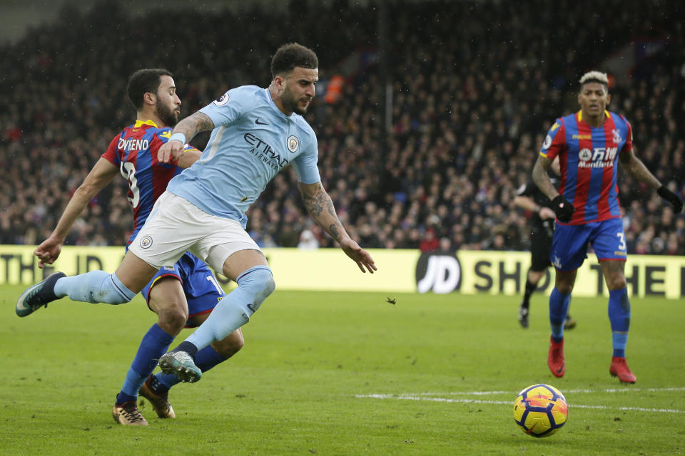 Kyle Walker (front) and Manchester City were tripped up by Crystal Palace, ending their 18-game win streak. (AP)