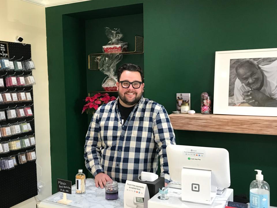 Pappy's Handcrafted Candles owner Kevin Avery greets customers at his New Brighton store. That's a photo of his inspirational late-father, "Pappy" behind him.