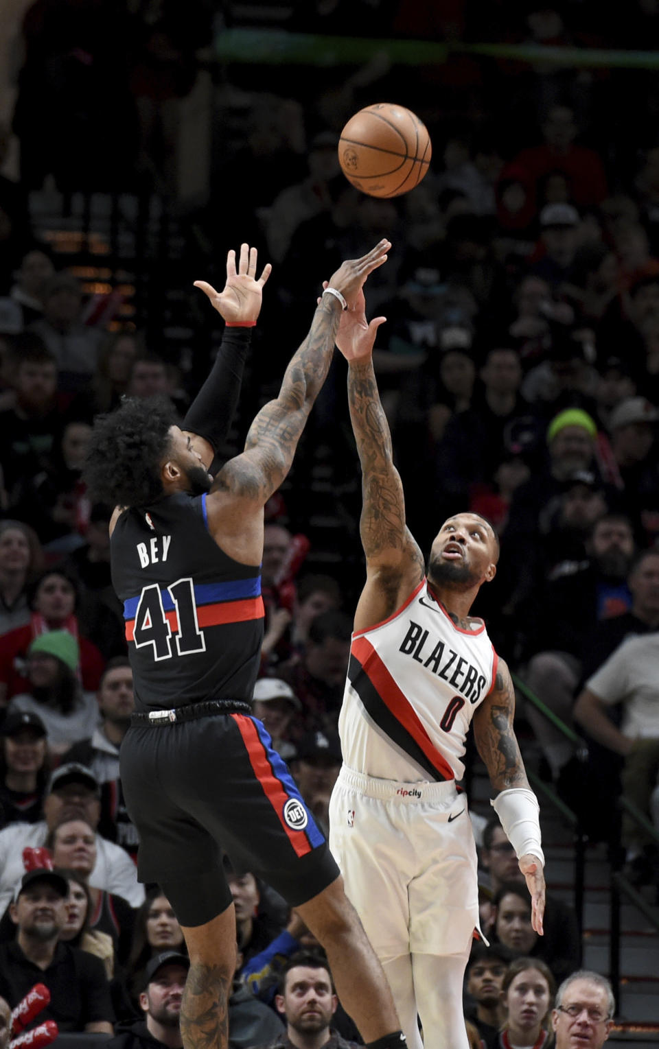 Portland Trail Blazers guard Damian Lillard, right, goes up block a shot by Detroit Pistons forward Saddiq Bey, left, during the first half of an NBA basketball game in Portland, Ore., Monday, Jan. 2, 2023. (AP Photo/Steve Dykes)