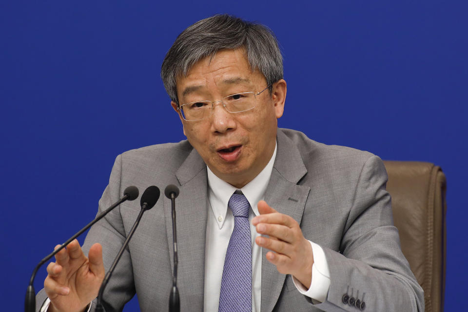 China's Central Bank Governor Yi Gang speaks during a press conference on the sideline of the National People's Congress at the media center in Beijing, Sunday, March 10, 2019. (AP Photo/Andy Wong)