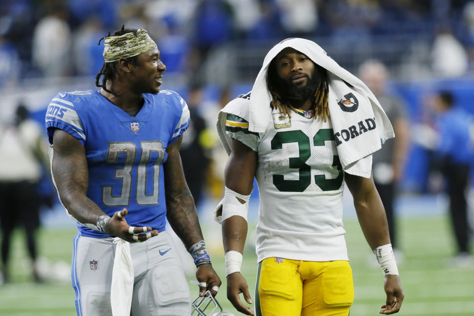 Detroit Lions running back Jamaal Williams (30) walks off the field with Green Bay Packers running back Aaron Jones (33) after an NFL football game, Sunday, Nov. 6, 2022, in Detroit. (AP Photo/Duane Burleson)