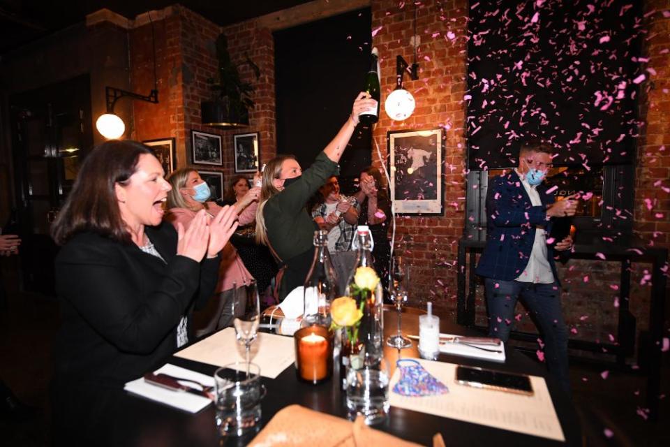 Patrons and staff celebrate inside Angus & Bon New York steakhouse in Melbourne just after midnight.