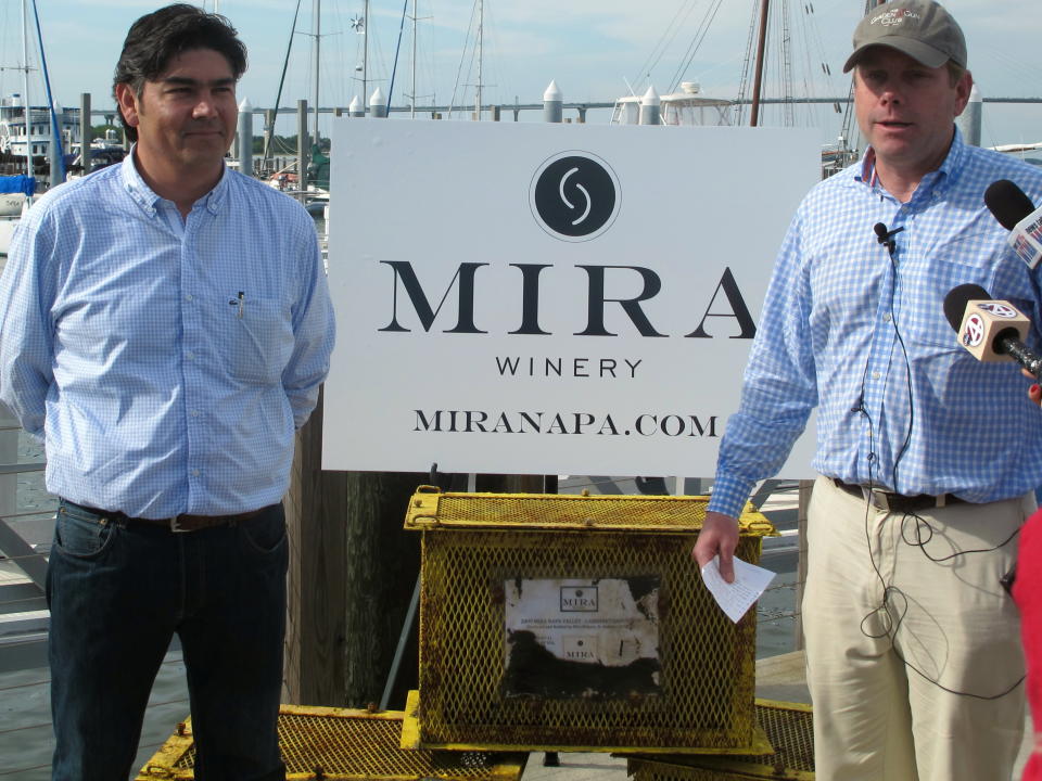 Gustavo Gonzalez, the winemaker for Mira Winery of St. Helena, Calif., left, and winery president Jim "Bear" Dyke Jr., speak with reporters in Charleston, S.C., on Tuesday, May 21, 2013 about the winery's experiment with ocean wine aging. Divers on Tuesday recovered four cases of wine that had been submerged in Charleston Harbor back in February. The winery is investigating what effect ocean aging has on wine. (AP Photo/Bruce Smith)