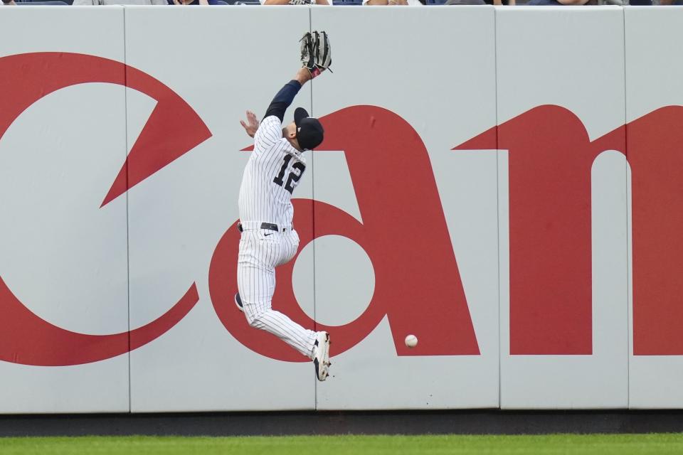 New York Yankees' Isiah Kiner-Falefa (12) dives for a ball hit by Baltimore Orioles' Adley Rutschman for an RBI double during the third inning of a baseball game Monday, July 3, 2023, in New York. (AP Photo/Frank Franklin II)