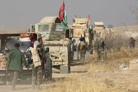 Military vehicles of Peshmerga forces drive towards the town of Bashiqa, east of Mosul, during an operation to attack Islamic State militants in Mosul, Iraq, November 7, 2016. REUTERS/Azad Lashkari