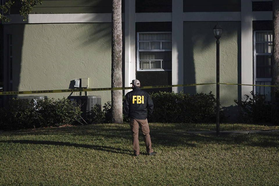 Law enforcement personnel continue to work at an apartment complex the day after a deadly shooting in Sunrise, Fla., Wednesday, Feb. 3, 2021. Several FBI agents were killed and others were wounded while trying to serve a search warrant on a child pornography suspect in Florida. FBI authorities say the suspect also died. (Joe Cavaretta/South Florida Sun-Sentinel via AP)