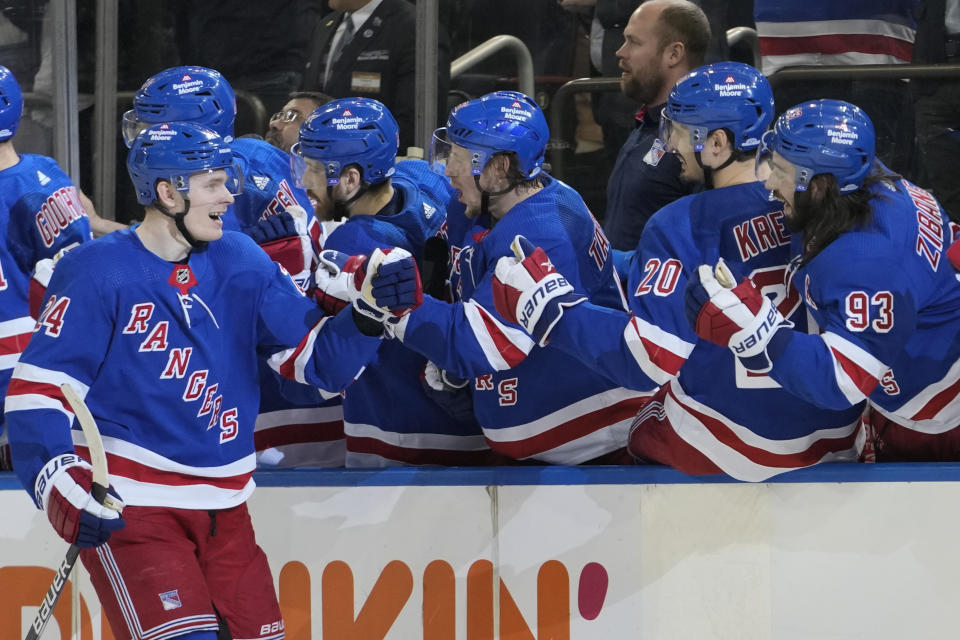 New York Rangers right wing Kaapo Kakko (24) is congratulated after scoring against the Carolina Hurricanes during the third period of an NHL hockey game Tuesday, March 21, 2023, at Madison Square Garden in New York. The Hurricanes won 3-2. (AP Photo/Mary Altaffer)