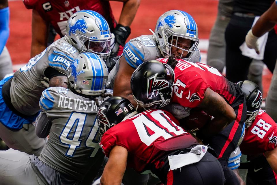 Detroit Lions defensive end Da'Shawn Hand (93) tackles Atlanta Falcons running back Todd Gurley II (21) near the goal line during the first half at Mercedes-Benz Stadium, Oct. 25, 2020.