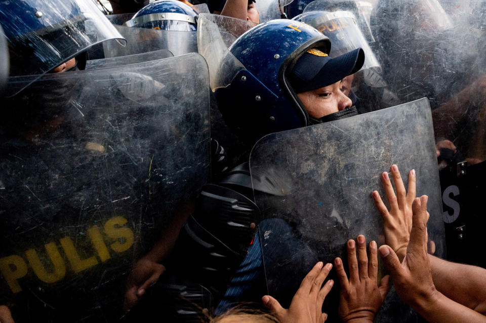 Police officers block activists during a protest denouncing the proclamation of the new Philippine president and vice president, in front of the Commission on Human Rights, in Quezon City, Metro Manila, on May 25.<span class="copyright">Lisa Marie David—Reuters</span>