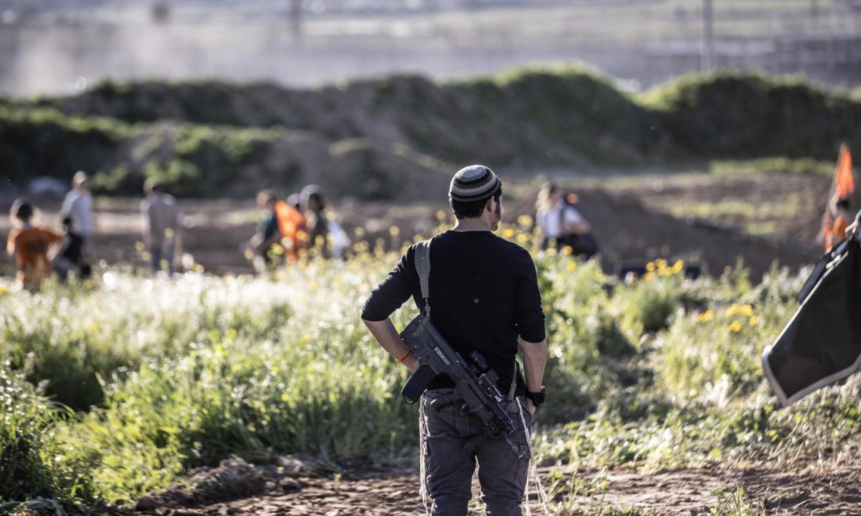 <span>Israeli settler activists. In the occupied West Bank, it can be difficult to distinguish between IDF soldiers and settlers in uniform, villagers say.</span><span>Photograph: Anadolu/Getty Images</span>