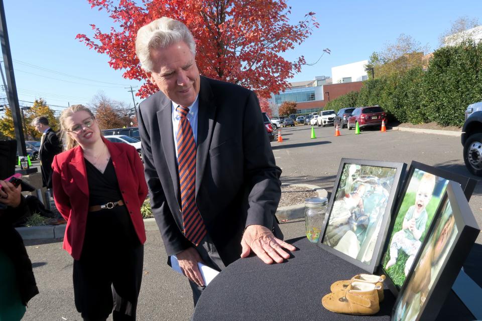 Congressman Frank Pallone (D-NJ) looks over photos of children injured or killed from water beads during a Monday, November 13, 2023, press conference outside Jersey Shore University Medical Center in Neptune, NJ. He is planning to introduce legislation to ban that product that are marketed for kids. Shown at left is Taylor Bethard, who lost her daughter Esther to ingesting water beads.