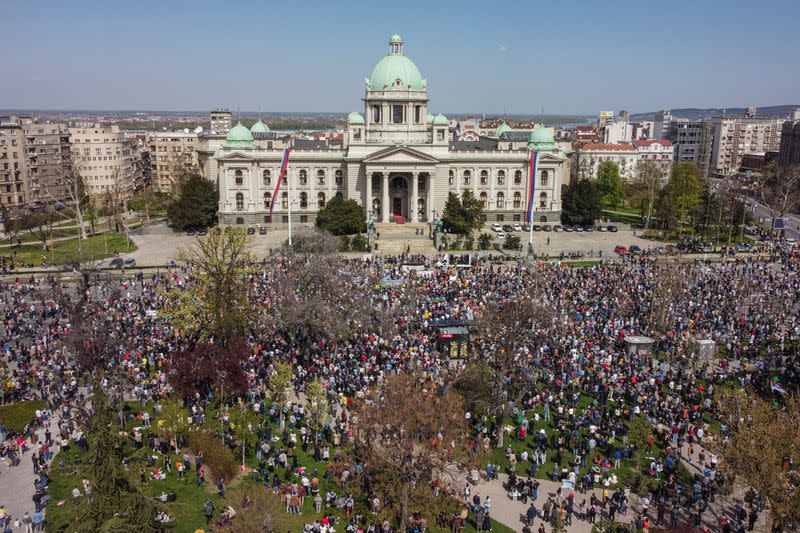 People attend a protest in front of the Serbian parliament in Belgrade