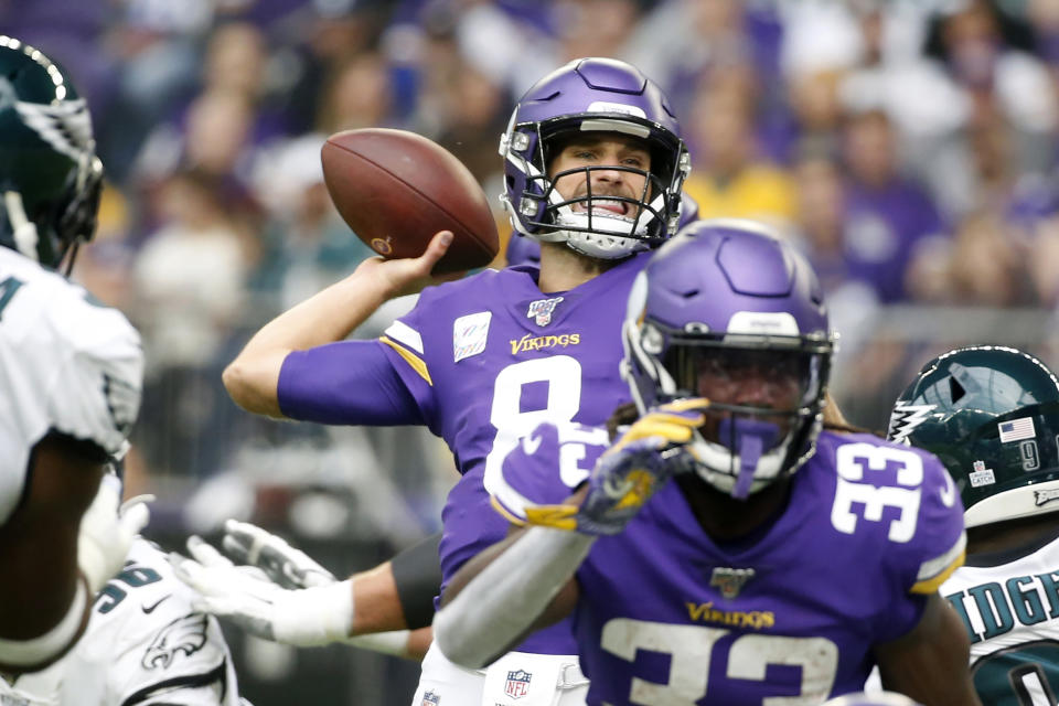 Minnesota Vikings quarterback Kirk Cousins, center, throws a pass during the first half of an NFL football game against the Philadelphia Eagles, Sunday, Oct. 13, 2019, in Minneapolis. (AP Photo/Bruce Kluckhohn)