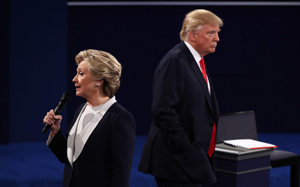 Democratic presidential nominee former Secretary of State Hillary Clinton speaks as Republican presidential nominee Donald Trump listens during the town hall debate at Washington University on Oct. 9, 2016 in St Louis, Missouri. | Win McNamee—Getty Images