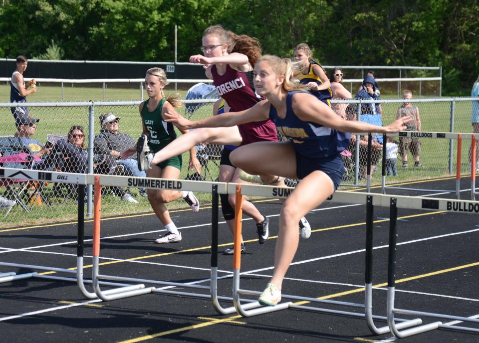 Kaylie Bash of Erie Mason and Morenci’s Leah Rorick battle for the lead in the high hurdles in the Tri-County Conference track and field championships at Summerfield Tuesday. Bash won the race.