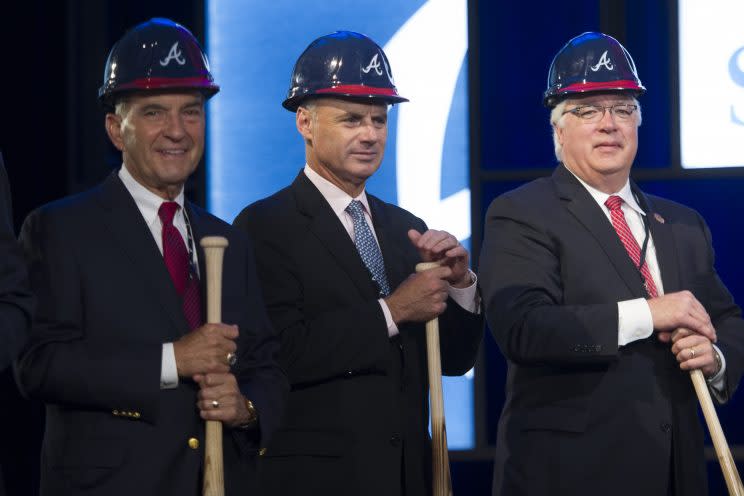 Baseball Commissioner Elect Rob Manfred, center, is seen with Atlanta Braves President John Schuerholz, left, and Cobb County Chairman Tim Lee, right, during a ground breaking ceremony for the Atlanta Braves new stadium which will be called SunTrust Park, Tuesday, Sept. 16, 2014, in Atlanta. The Braves will be moving from Turner Field in Fulton County to the new stadium being built in Cobb County in 2017. (AP Photo/John Amis)