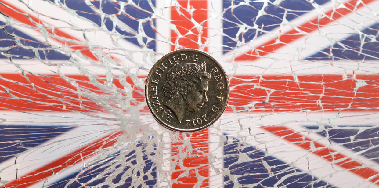 A pound coin is placed on broken glass and British flag in this illustration picture taken January 28, 2019. Photo: REUTERS/Dado Ruvic