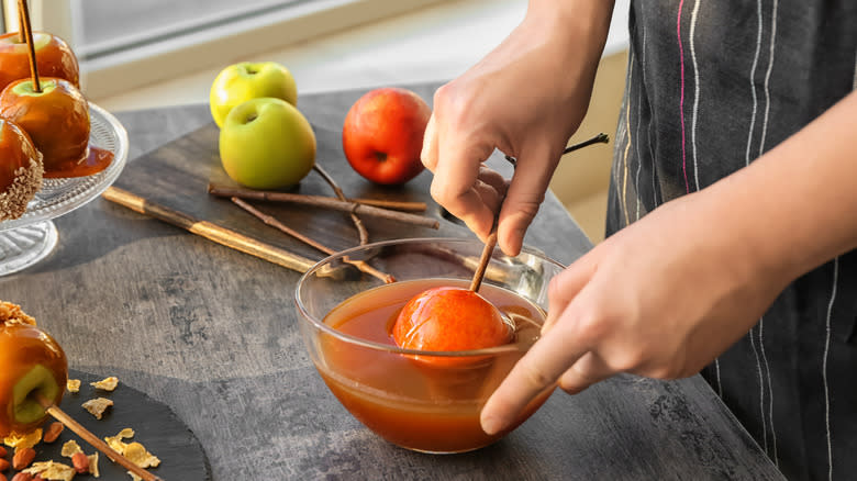 Apples dipped into caramel sauce