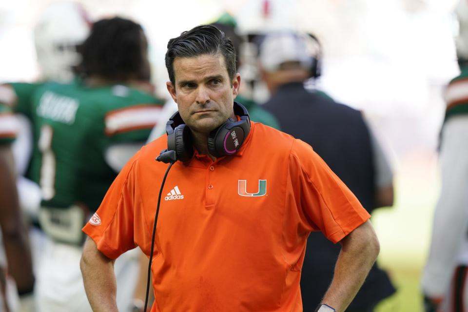 Miami head coach Manny Diaz looks on as officials review a play