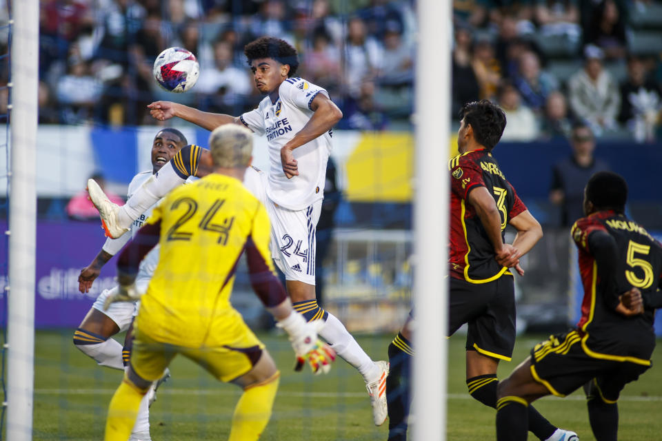 LA Galaxy defender Jalen Neal controls the ball as Seattle Sounders goalkeeper Stefan Frei, foreground left, defends during the second half of an MLS soccer match in Carson, Calif., Saturday, April1, 2023. (AP Photo/Ringo H.W. Chiu)