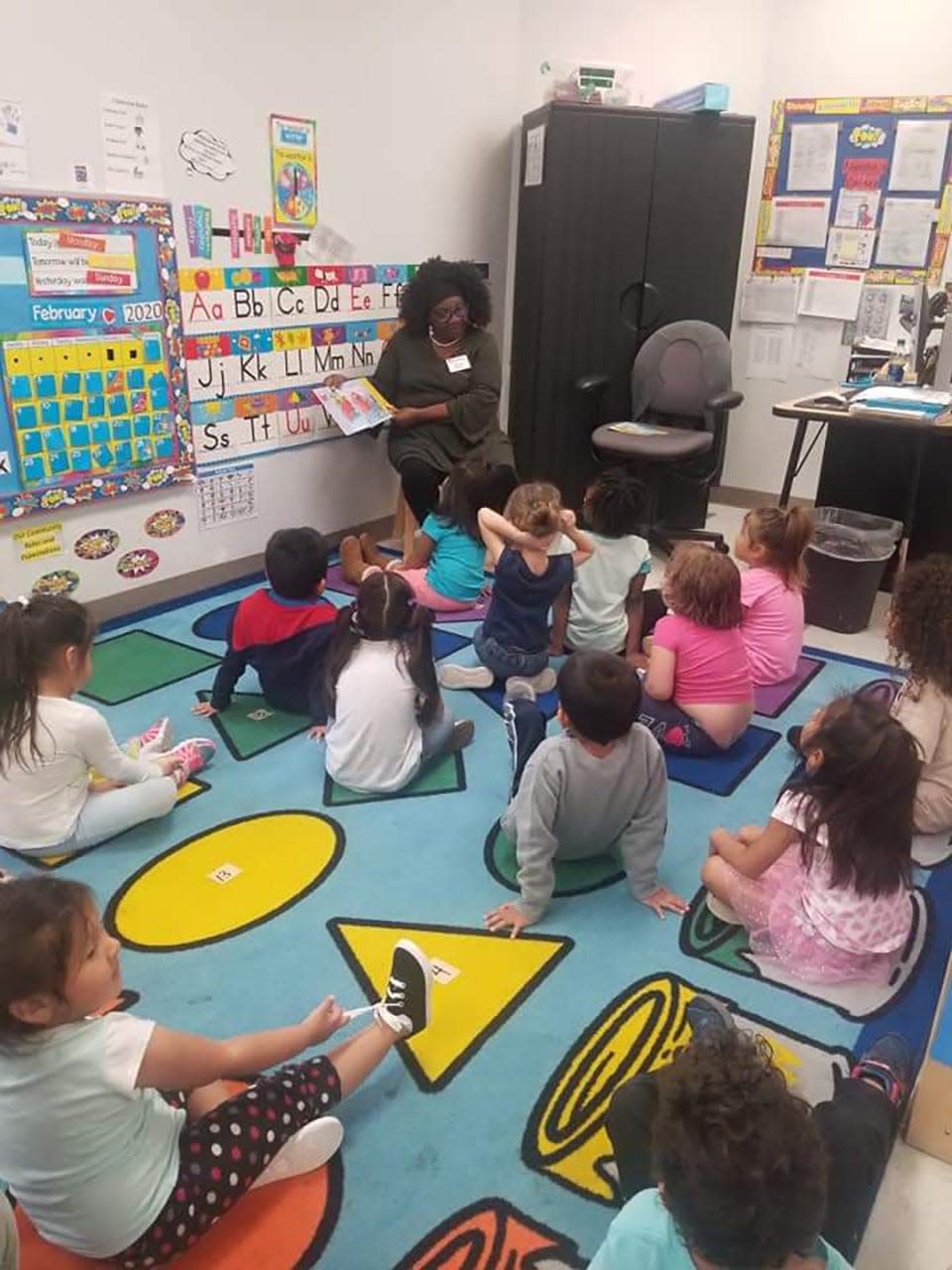 Sharon Moody reads to a class in Hillsborough County. Moody, who has a long history of volunteering with kids, has been named the governor of the Kiwanis district serving Florida and the Caribbean.