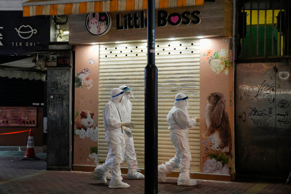 Pictured are Staff members from Agriculture, Fisheries and Conservation Department investigate at a pet shop, closed after some pet hamsters were, authorities said, tested positive for the coronavirus.