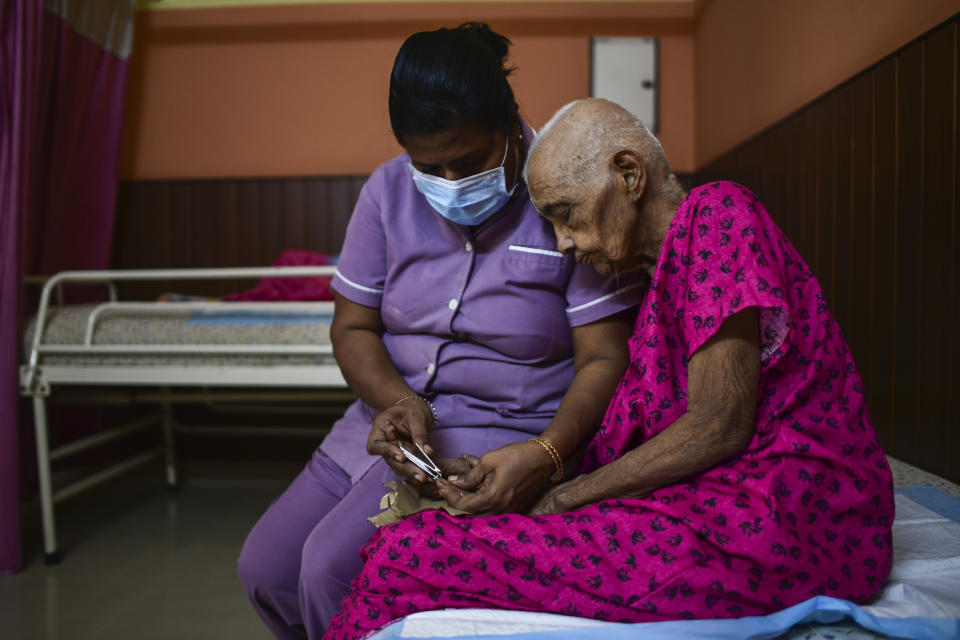 Mini, a nurse, trims the nails of elderly woman Saradammal at the Signature Aged Care in Kochi, Kerala state, India, March 6, 2023. In the last 60 years, the percentage of those aged 60 and over in India's Kerala state has shot up from 5.1% to 16.5% — the highest proportion in any state. This makes Kerala an outlier in a country with a rapidly growing population, soon to be the world’s most populous at 1.4 billion. (AP Photo/ R S Iyer)