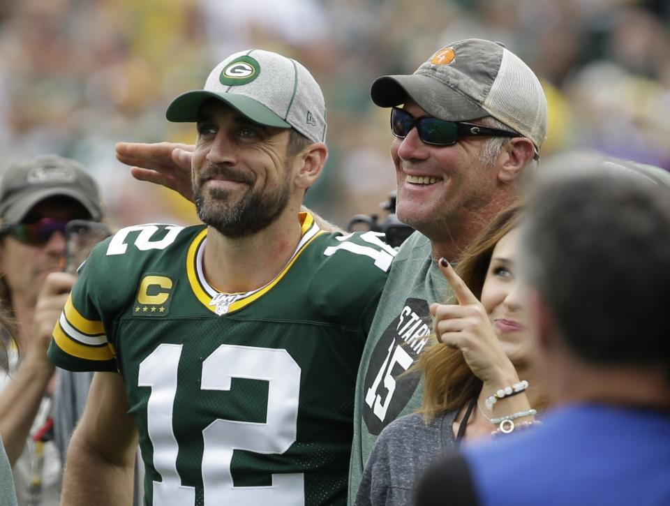 Green Bay Packers' Aaron Rodgers smiles with former quarterback Brett Favre in 2019