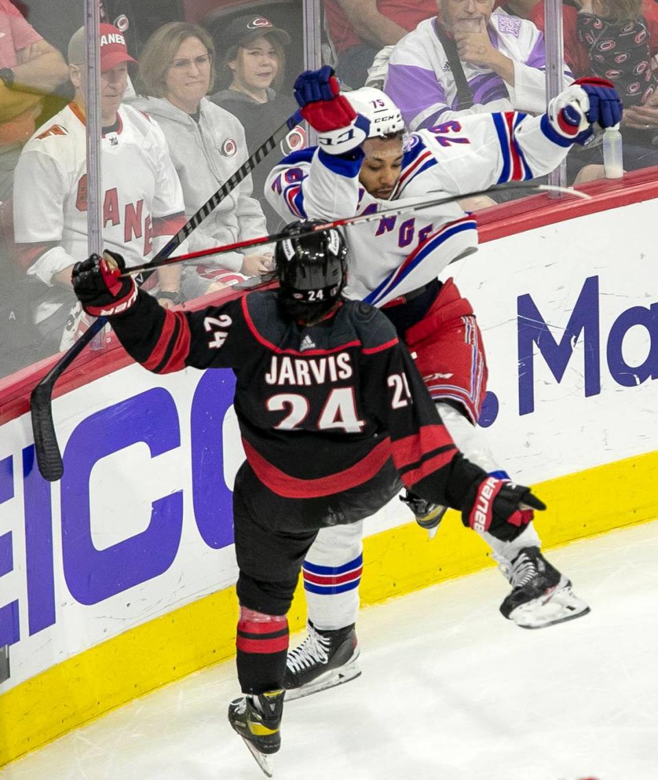New York Rangersí Ryan Reaves (75) checks Carolina Hurricanesí Seth Jarvis (24) in the second period on Wednesday, May 18, 2022 during game one of the Stanley Cup second round at PNC Arena in Raleigh, N.C.