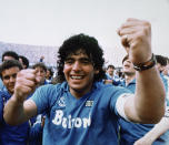 FILE - Argentine soccer superstar Diego Armando Maradona cheers after the Napoli team clinched its first Italian major league title in Naples, Italy, on May 10, 1987. It's a celebration more than 30 years in the making, and historically superstitious Napoli fans are already painting the city blue in anticipation of the team's first Italian league title since the days when Diego Maradona played for the club. (AP Photo/Massimo Sambucetti, File )