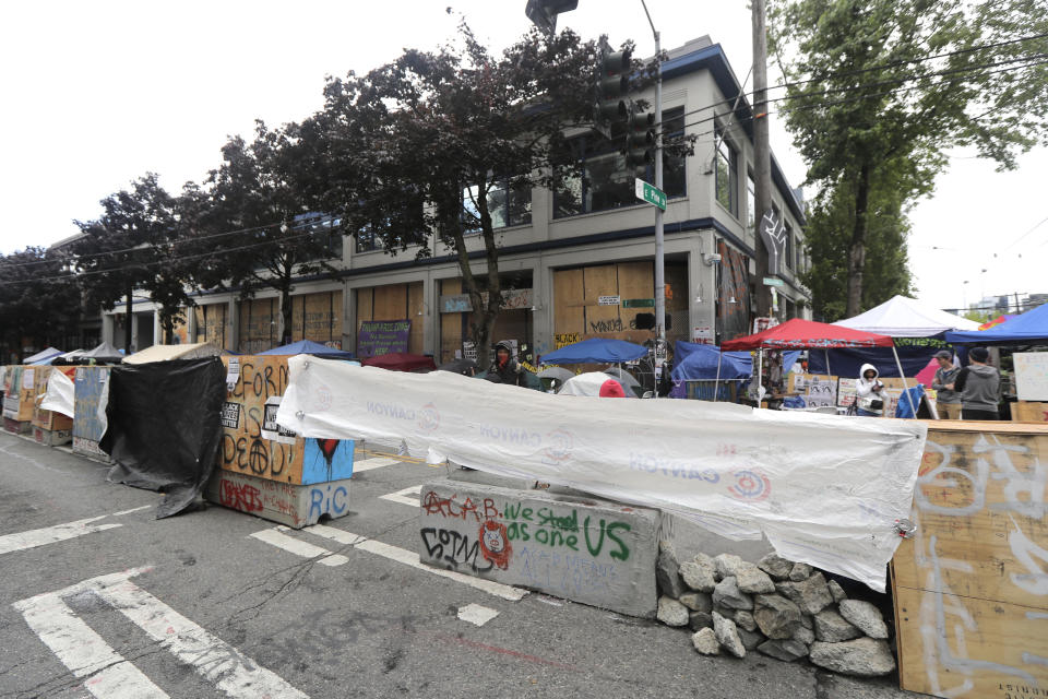 Cement barricades are fortified with chunks of concrete and tarps in front of the Seattle Police Department East Precinct building, Tuesday, June 30, 2020 at the CHOP (Capitol Hill Occupied Protest) zone in Seattle. Earlier Tuesday, Seattle Department of Transportation workers removed barricades two blocks away at the intersection of 10th Ave. and Pine St. The area has been occupied by protesters since Seattle Police pulled back from their East Precinct building following violent clashes with demonstrators earlier in the month. (AP Photo/Ted S. Warren)