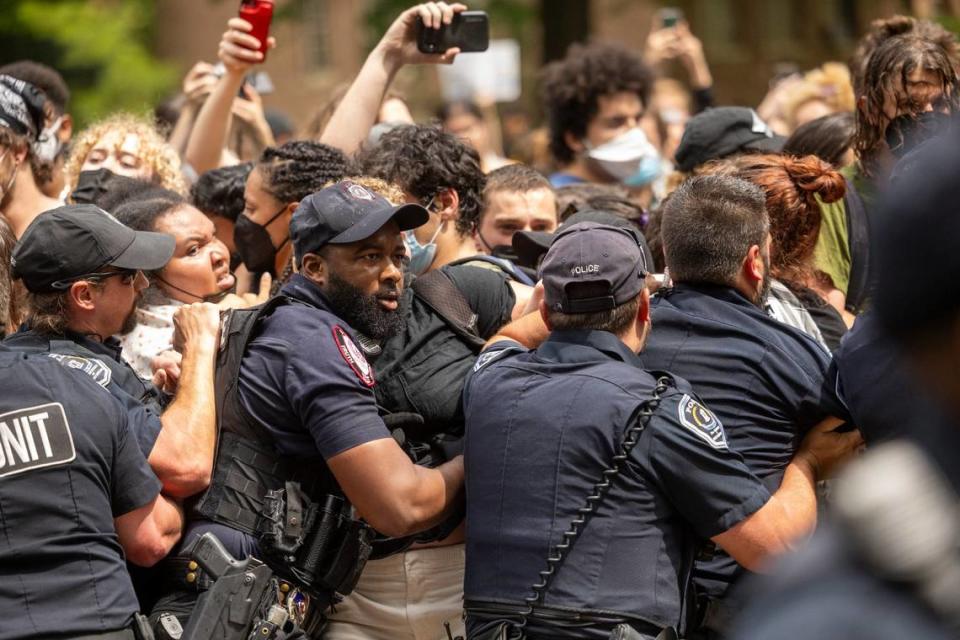 Pro-Palestinian demonstrators clash with police after replacing an American flag with a Palestinian flag Tuesday, April 30, 2024 at UNC-Chapel Hill. Police removed a “Gaza solidarity encampment” earlierTuesday morning.