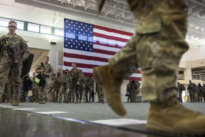 Over 180 soldiers with the U.S. Army 3rd Infantry Division, 1st Armored Brigade Combat Team prepare to board a charter flight during their deployment to Germany from Hunter Army Airfield, Wednesday March 2, 2022 in Savannah, Ga. The division is sending 3,800 troops as reinforcements for various NATO allies in Eastern Europe. (Stephen B. Morton /Atlanta Journal-Constitution via AP)