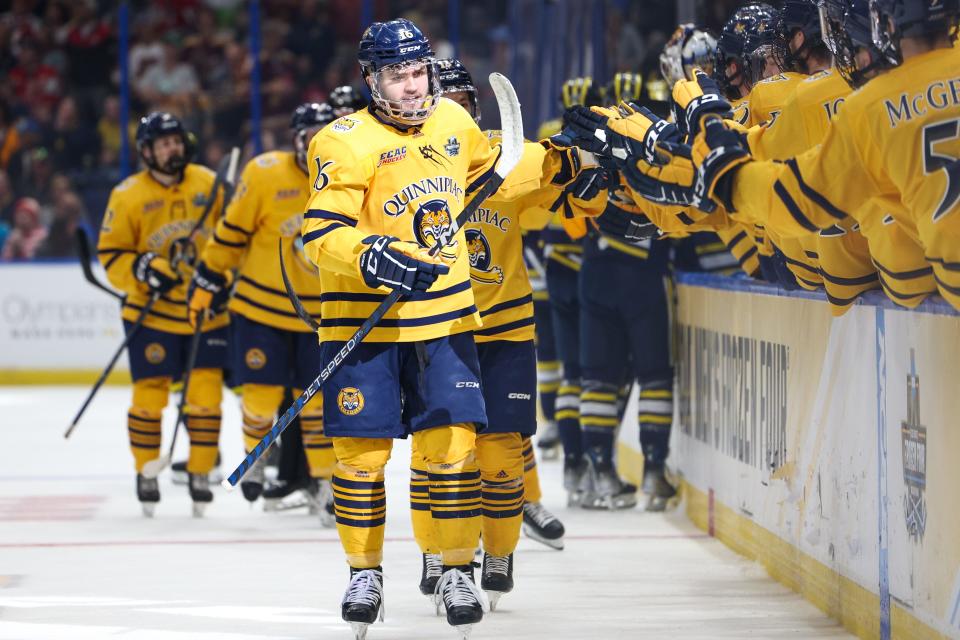 Quinnipiac forward Jacob Quillan (16) celebrates a goal against Michigan during the first period in the semifinals of the 2023 Frozen Four at Amalie Arena in Tampa, Florida, on Thursday, April 6, 2023.