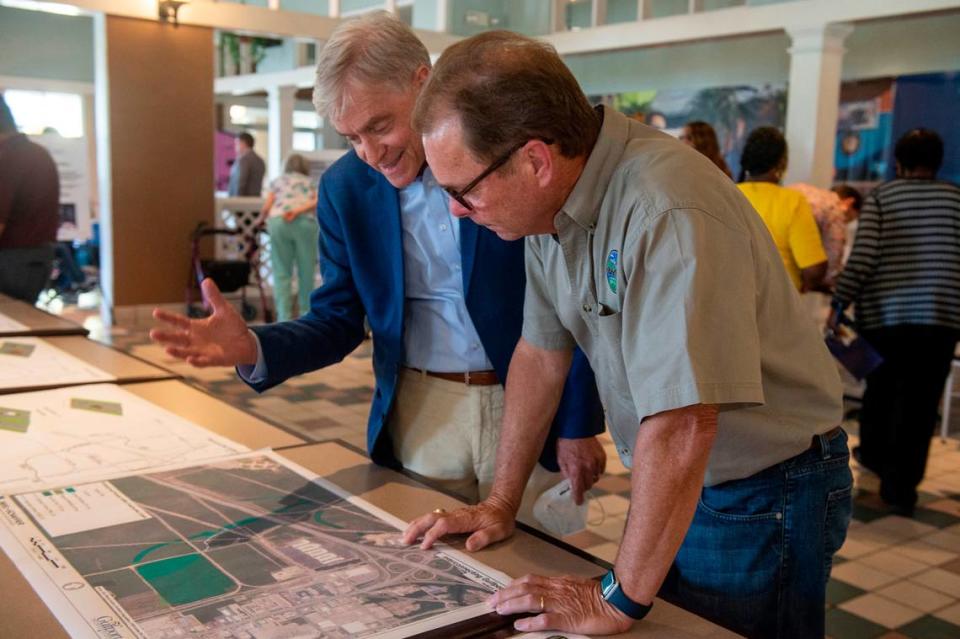 Gulfport Mayor Billy Hewes looks over plans for a potential road development with environmental lawyer Robert Wyigul at a public hearing at Gulfport Premium Outlets on Wednesday, July 13, 2022. The plan has faced criticism from nearby residents that it will have negative environmental impacts and cause more flooding.