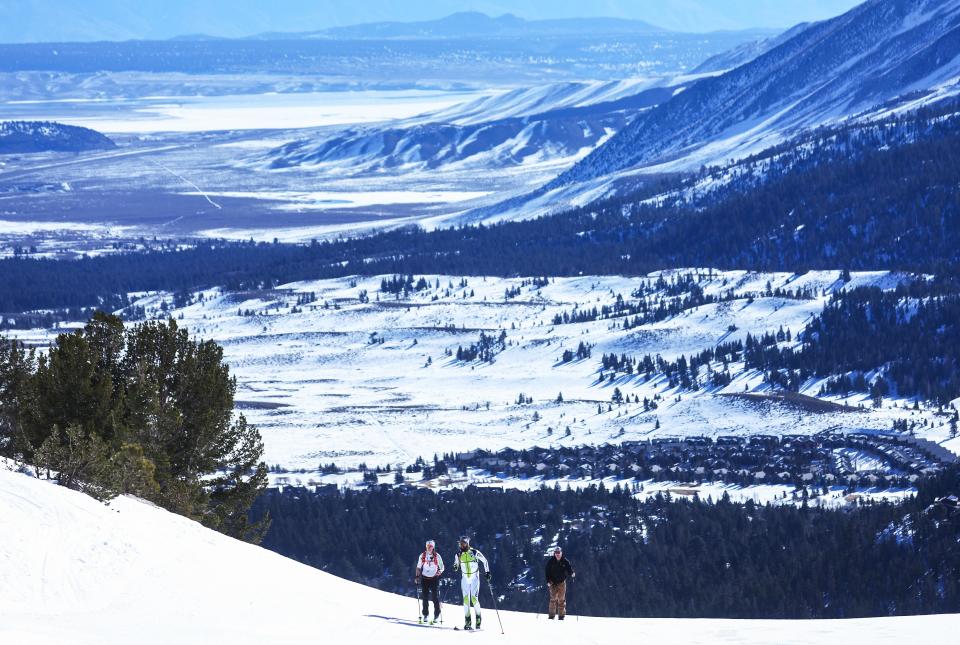 Uphill skiers ascend a designated uphill trail at Mammoth Mountain on February 18, 2022 in Mammoth Lakes, California