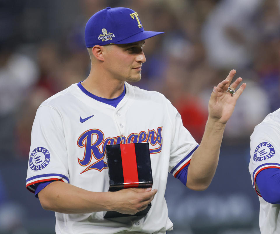 Texas Rangers' Corey Seager waves to the crowd after receiving his World Series ring before a baseball game against the Chicago Cubs, Saturday, March 30, 2024, in Arlington, Texas. (AP Photo/Gareth Patterson)