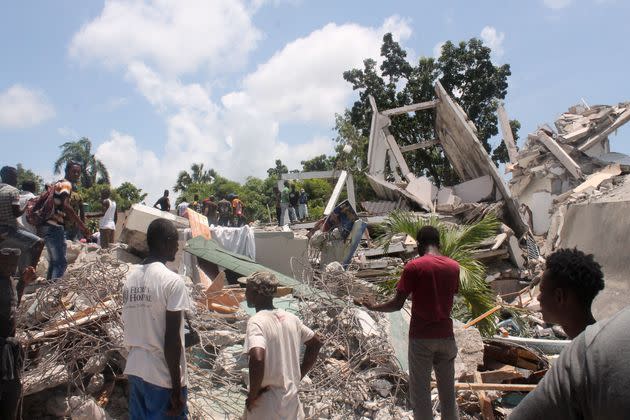 TOPSHOT - People search through the rubble of what used to be the Manguier Hotel after the earthquake hit on August 14, 2021 in Les Cayes, southwest Haiti. - Rescue workers scrambled to find survivors after a powerful 7.2-magnitude earthquake struck Haiti early Saturday, killing at least 304 and toppling buildings in the disaster-plagued Caribbean nation still recovering from a devastating 2010 quake.
The epicenter of the shaking, which rattled homes and sent terrified locals scrambling for safety, was about 100 miles (160 kilometers) by road west of the center of the densely populated capital Port-au-Prince. (Photo by Stanley LOUIS / AFP) (Photo by STANLEY LOUIS/AFP via Getty Images) (Photo: STANLEY LOUIS/AFP via Getty Images)