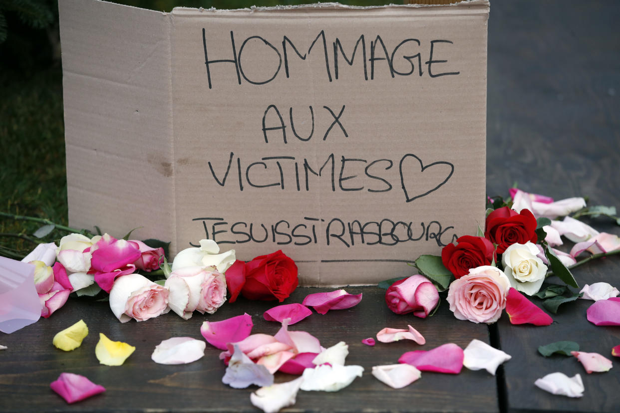 A sign honoring the victims of a shooting in Strasbourg, France