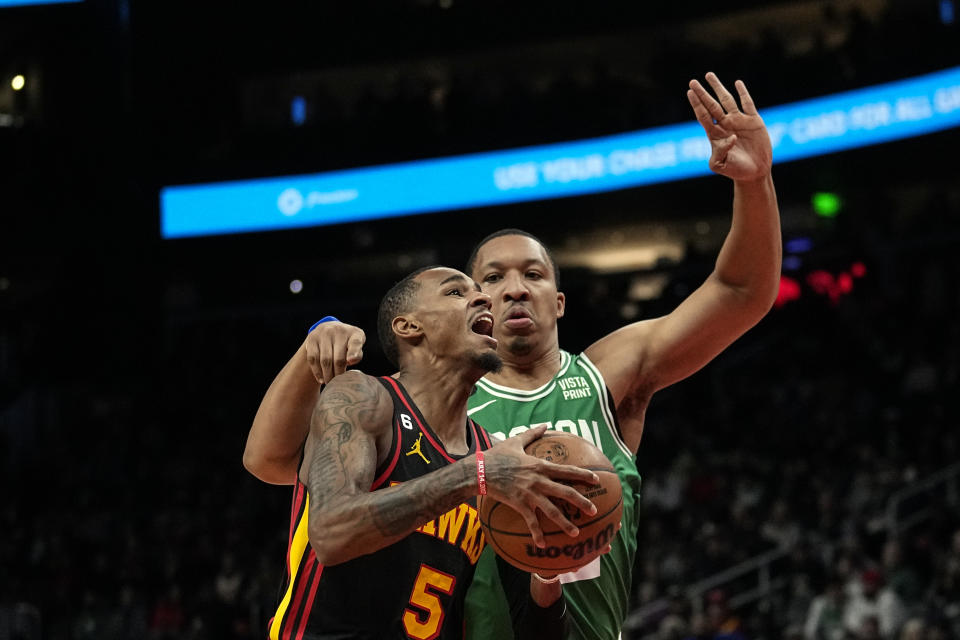 Atlanta Hawks guard Dejounte Murray (5) drives against Boston Celtics forward Grant Williams (12) during the first half of an NBA basketball game Wednesday, Nov. 16, 2022 in Atlanta. (AP Photo/John Bazemore)