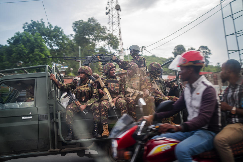 Kenyan forces drive through Goma, Democratic Republic of Congo Friday Nov. 25, 2022. Mediators are calling for a cease-fire to begin Friday evening in eastern Congo. But it remains unclear whether that will happen as M23 rebels officially were not included at Wednesday's summit in Angola. (AP Photo/Jerome Delay)