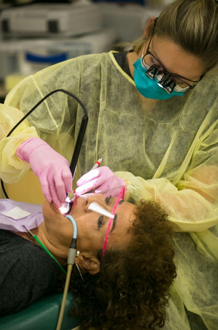 A University of Florida cleans a patient&#39;s teeth at the ACORN Clinic in Brooker in 2017.