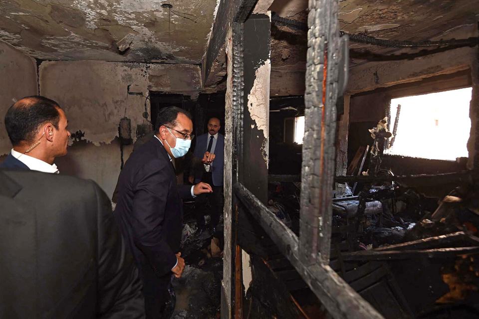 This handout image provided by the office of Egypt's Prime Minister shows Prime Minister Mostafa Madbouli (C) visiting the Abu Sifin Coptic church after a fire broke out during a Sunday service in a working-class district of Greater Cairo on August 14, 2022.