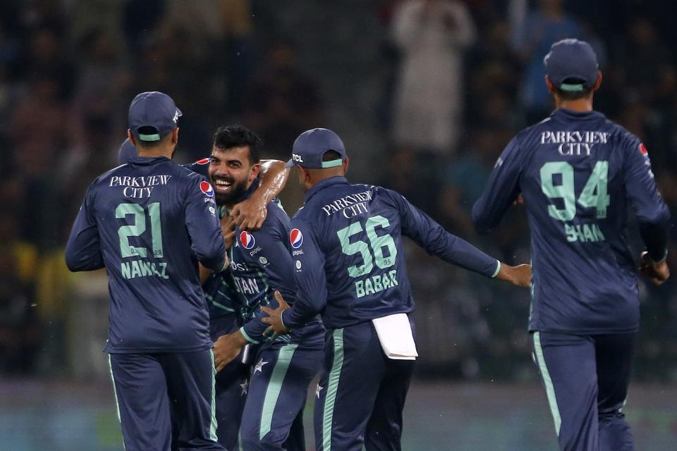 Pakistan's Shadab Khan, section left, celebrates with teammates after the dismissal of England's Phil Salt during the seventh twenty20 cricket match between Pakistan and England, in Lahore, Pakistan, Sunday, Oct. 2, 2022. (AP Photo/K.M. Chaudary)